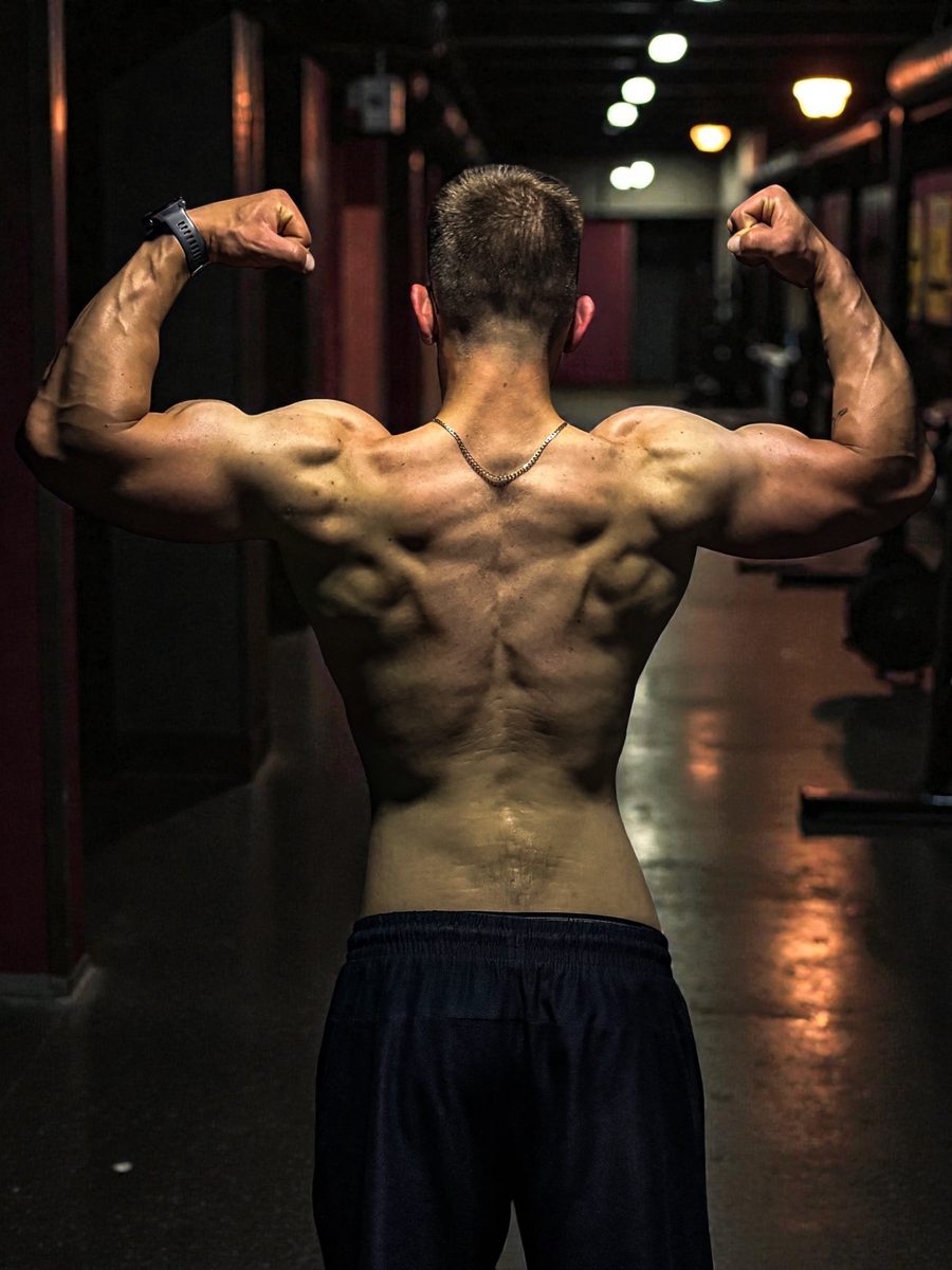 Back muscles double bicep pose showing training results