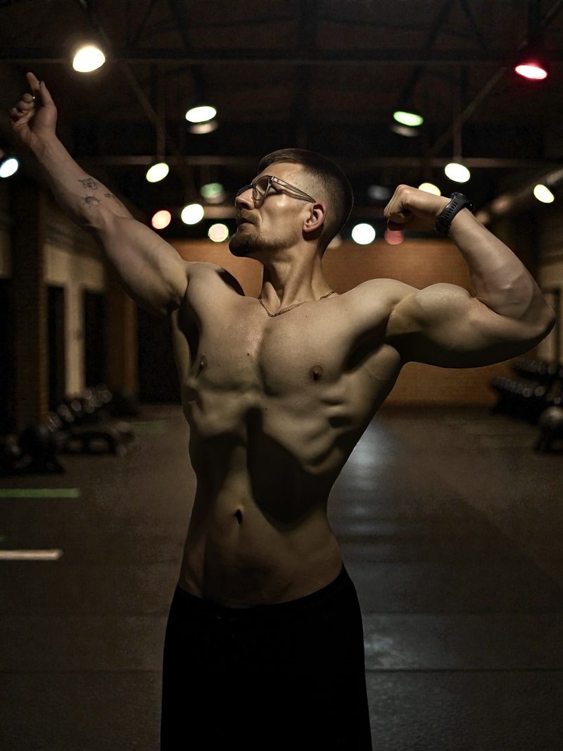 Personal trainer showing muscle definition and physique