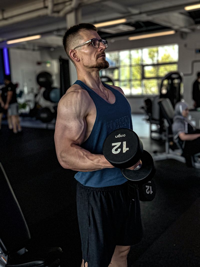 Standing dumbbell bicep curl exercise in gym